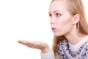 Blonde womn sending air kiss on palm hand