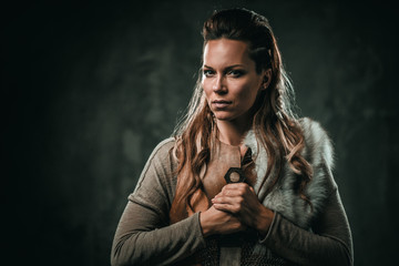 Fototapeta na wymiar Viking woman with cold weapon in a traditional warrior clothes