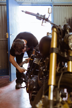 Man working on bike in shop