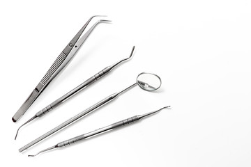 teeth care with dentist instruments in doctor's office white background top view mock-up