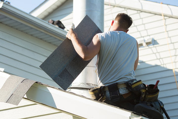 Roofer installing new roof on house - obrazy, fototapety, plakaty