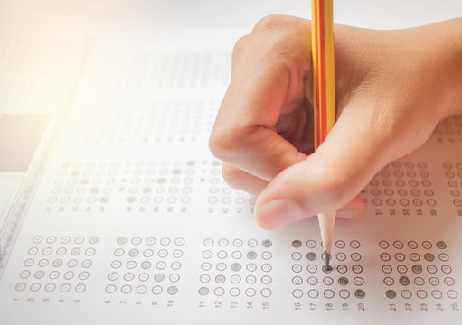 Asian student testing in exercise, exams answer sheets with pencil in class room