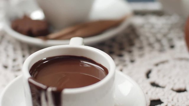 hand mixing chocolate in a hot milk, preparing hot chocolate or cacao, bautiful soft focus shot (uhd)