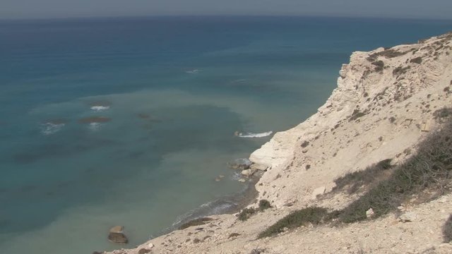Waves gently wash ashore on Cyprus beach, high angle