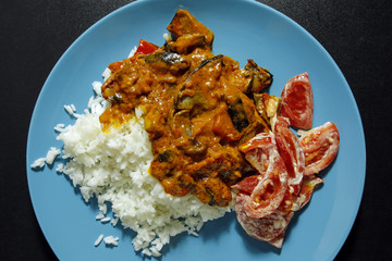 closeup of indian food with rice and tomato salad