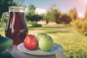 Glass of sweet homemade fruit compote on rusty table