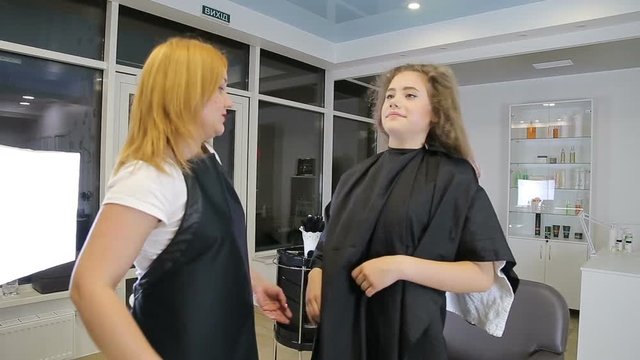 Professional Hair Dresser dries hair of teen cute girl