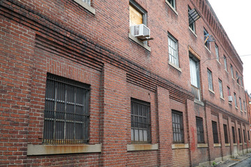 perspective view of brick wall and window of old factory building