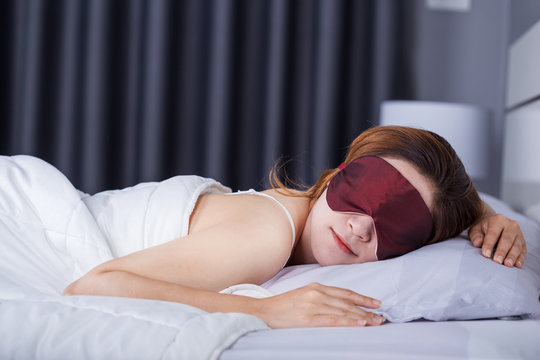 Woman Sleeping On Bed With Eye Mask