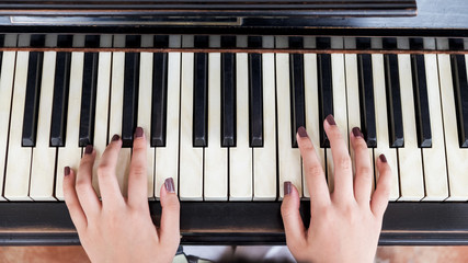 Close-up of a music performer's hand playing the piano