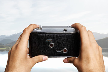 Old analog camera on male hands
