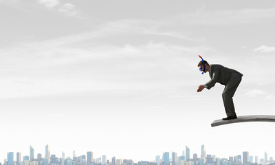 Businessman diving from top . Mixed media