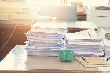 Fototapeta na wymiar Pile of unfinished documents on office desk, Stack of business paper, Vintage Effect