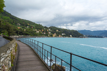 Obraz premium Rocks and the sea near Santa Margherita Ligure, Italy. A picturesque promenade, rocks and the sea