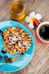 Photo of waffles with berries on wooden background