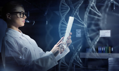 Scientist woman using tablet pc. Mixed media