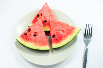 Watermelon slices put on the plate on white background