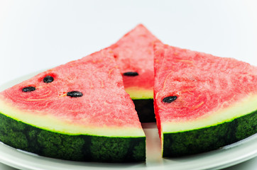 Watermelon slices put on the plate on white background