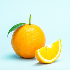 Orange fruit slice isolated on blue background.
