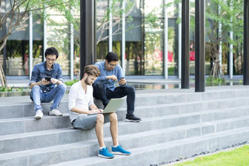 Group of Asian and Multiethnic Business people man with casual suit using laptop with happy and celebrate action at the outdoor, people business group concept. Feeling funny and enjoy.