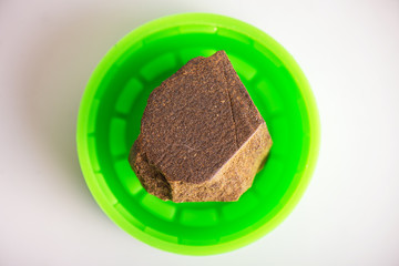 Single piece of cannabis extraction aka hashish isolated over white background