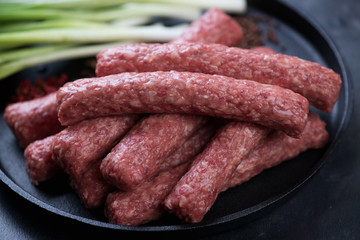 Close-up of cevapcici or skinless beef sausages, traditional dish in the Balkans. Selective focus, shallow depth of field