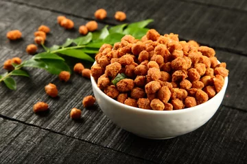  Indian masala coated peanuts in white bowl. © susansam90