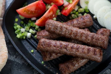 Close-up of barbecued cevapcici or skinless beef sausages, selective focus