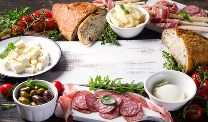 Various types of italian food on  white wooden table