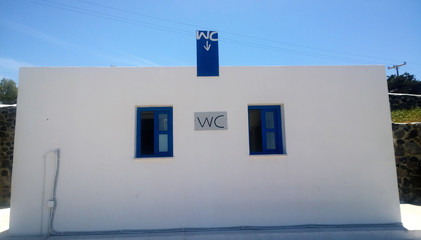 Detached building toilet in white-blue colors on the island of Santorini in Greece