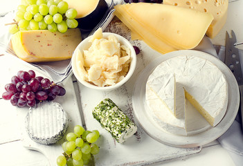 Delicious cheese  with grapes on a wooden table