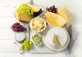Delicious cheese  with grapes on a wooden table