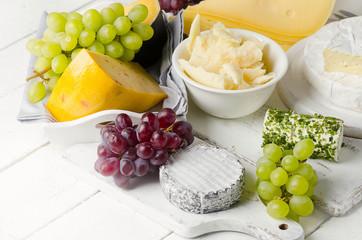 Delicious cheese  with grapes on a wooden table