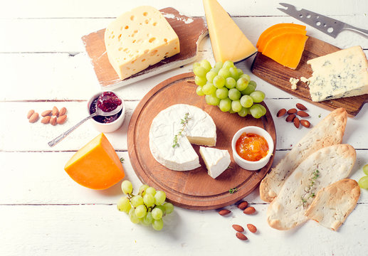 Different kinds of cheeses  with grapes, nuts