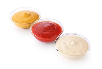 Bowls with ketchup mustard and mayonnaise isolated on white background.