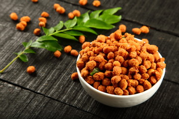 Bowl of  spicy coated peanuts.