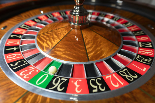 American Roulette wheel with a ball in the number '0'