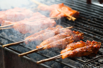Grill chicken in bamboo stick , street food of Thailand.