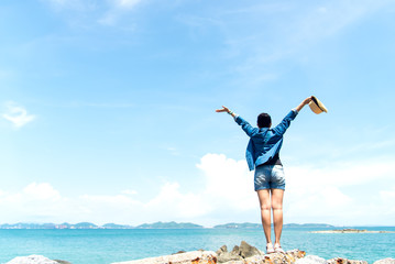 Happy woman on the beach in summer.