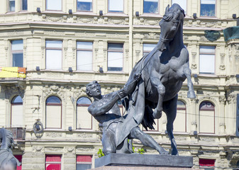 Fototapeta na wymiar Sculpture of the tamer of horses on Anichkov Bridge St. Petersburg in Russia the city 