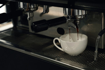 Coffee pouring from coffee in a white up
