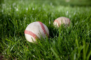 Baseballs in green grass