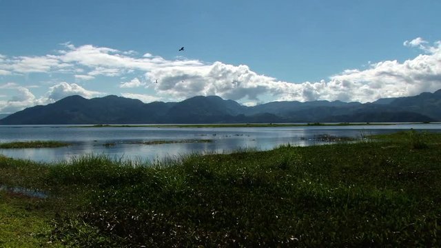 Static shot of beautiful calm Lake Yojoa in Honduras. Mountains on the background