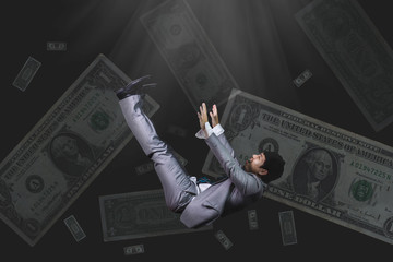 falling and screaming businessman in formal wear bank note on black background(bankrupt concept)