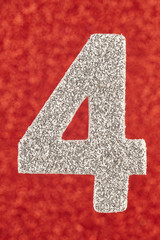 Number four silver color over a red background. Anniversary.