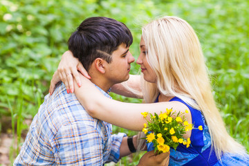 summer holidays, love, romance and people concept - happy loving couple hugging outdoors