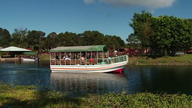 Tourists taking boat trip on the beautiful Lake Yojoa nearby hotel Las Glorias in Honduras