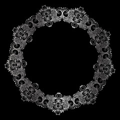 drawing of a round silver gradient frame with floral ornament on a black background