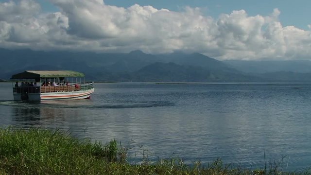 People taking boat trip on the beautiful Lake Yojoa nearby hotel Las Glorias in Honduras