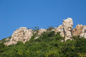 Fototapeta na wymiar Tall sharp cliff of Khao Sam Muk mountains, in Chonburi, Thailand